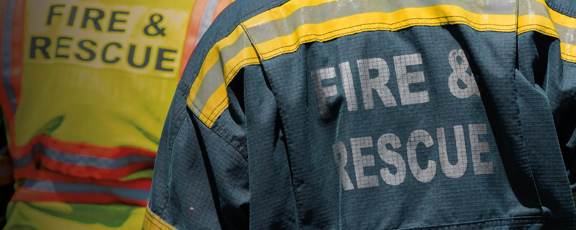 The back of two London firefighters in uniform